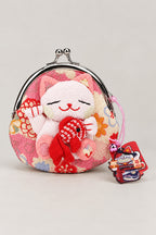 Gamagucci – pink gamaguchi clasp purse with plush lucky cat holding a fish and a charm, Japanese maneki neko coin purse, studio view