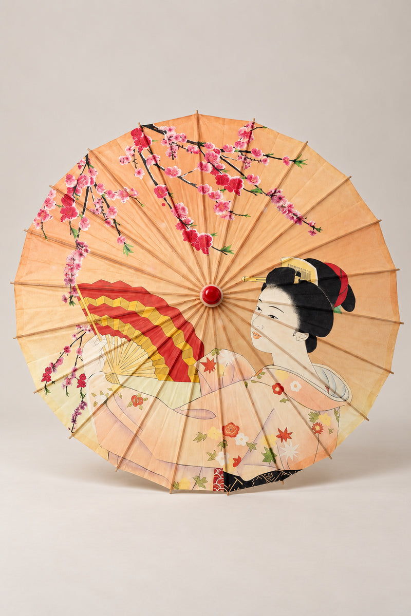 Geisha Fan Japanese Parasol 'Senmen' – peach parasol printed with a woman in kimono holding a fan among plum blossom and maple, Japanese wagasa parasol with wooden frame and paper-effect canopy, open, studio view