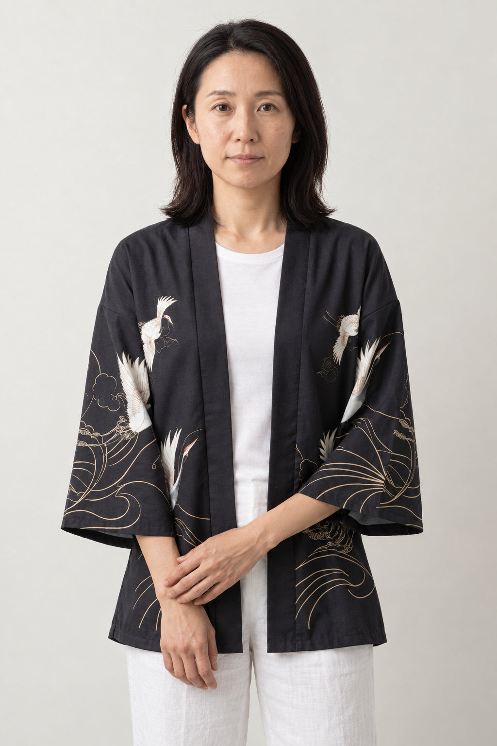 Gold Line Crane Kimono Jacket 'Kinpa' – black women's kimono jacket with gold line crane and wave print, Japanese haori style cardigan, front view on model