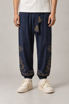 Golden Cloud Tobi Pants 'Saiun' – navy tobi pants with golden cloud embroidery and obi sash, Japanese workwear style trousers, front view on model