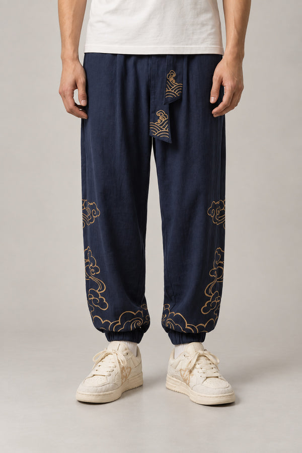 Golden Cloud Tobi Pants 'Saiun' – navy tobi pants with golden cloud embroidery and obi sash, Japanese workwear style trousers, front view on model