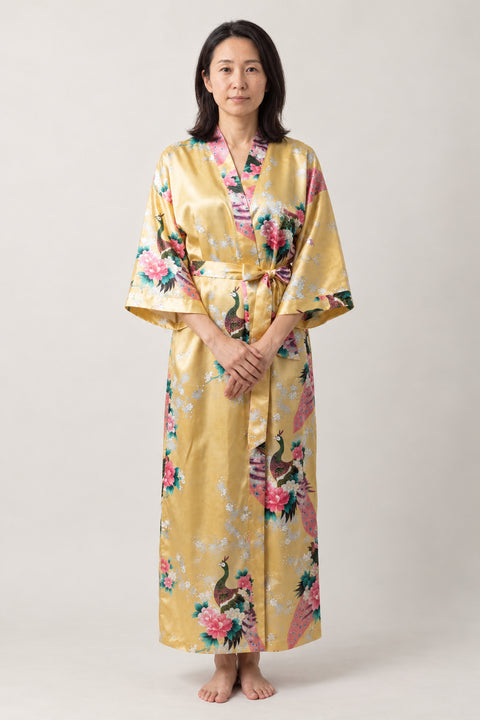Golden Crane Evening Robe 'Kinshou' – gold yellow women's long satin-look kimono evening robe with crane and floral print, Japanese dressing gown, front view on model