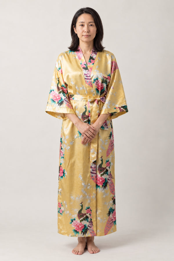 Golden Crane Evening Robe 'Kinshou' – gold yellow women's long satin-look kimono evening robe with crane and floral print, Japanese dressing gown, front view on model