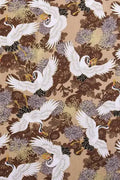 Golden Crane Furoshiki Fabric 'Kinzuru' – beige furoshiki printed with white cranes in flight over brown and gold chrysanthemums, Japanese furoshiki wrapping cloth 50 by 145 cm, close-up of the print