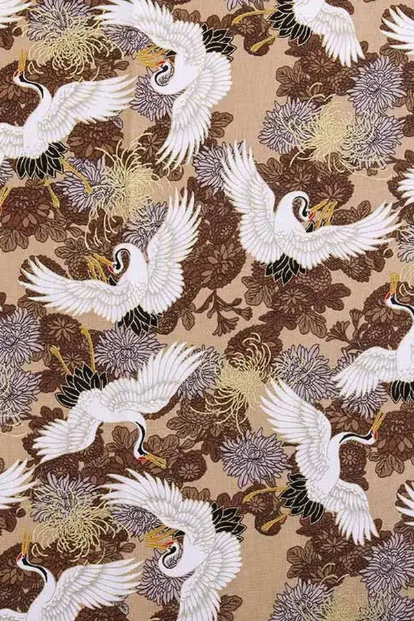 Golden Crane Furoshiki Fabric 'Kinzuru' – beige furoshiki printed with white cranes in flight over brown and gold chrysanthemums, Japanese furoshiki wrapping cloth 50 by 145 cm, close-up of the print