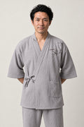 Grey Bamboo Japanese Pyjamas 'Madake' – light grey jinbei pyjamas with bamboo embroidery, unisex two-piece Japanese jinbei set with side-tie top and shorts, front view on model