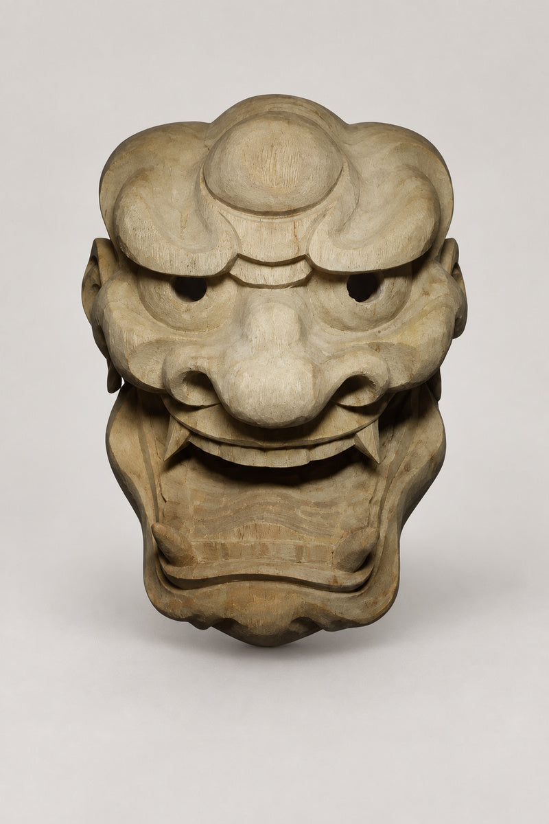 Hand Carved Japanese Mask 'Shimen' – unpainted wooden demon mask with wide roaring mouth, fangs and knotted brow, hand carved wooden Japanese mask for the wall, studio view