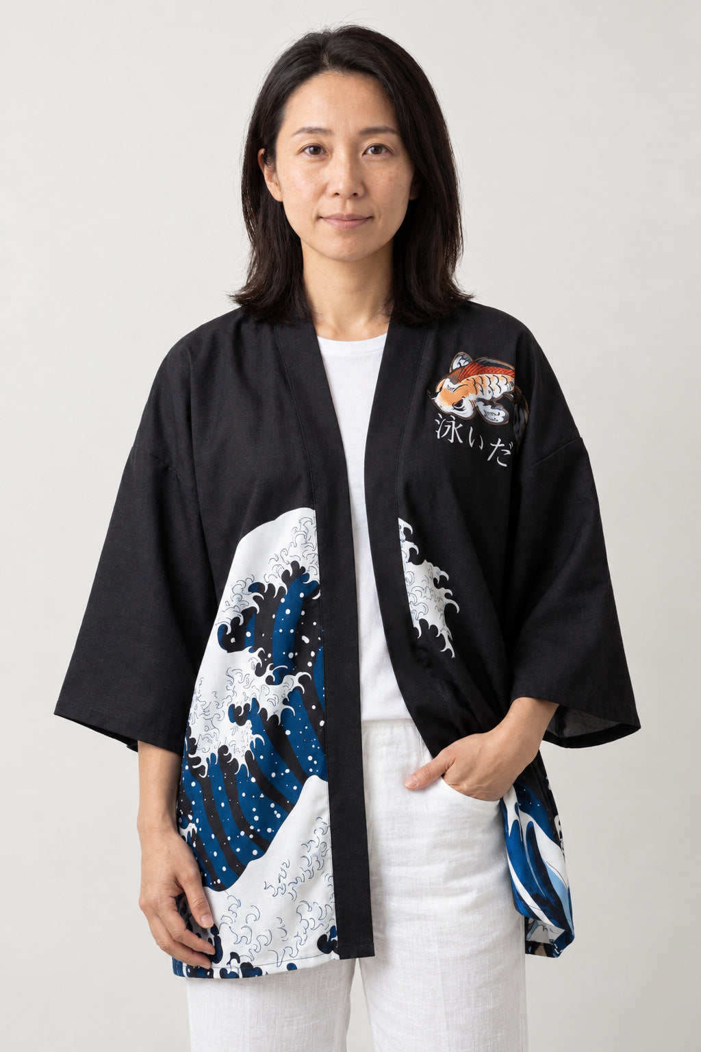 Hokusai Wave Kimono Jacket 'Okinami' – black women's kimono jacket with Hokusai great wave print on the hem, Japanese haori style cardigan, front view on model