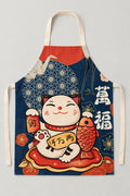 Japanese Apron – navy bib apron printed with a lucky cat holding a fish and gold kanji, Japanese maneki neko kitchen apron with neck loop and waist ties, studio view