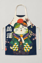Japanese Apron – navy bib apron printed with a lucky cat in a green kimono, Japanese maneki neko kitchen apron with neck loop and waist ties, studio view