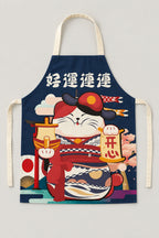 Japanese Apron – navy bib apron printed with a lucky cat in a red kimono holding a ship, Japanese maneki neko kitchen apron with neck loop and waist ties, studio view