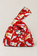 Japanese Knot Bag – red Japanese knot bag with lucky cat and fan print, kimono cloth handbag with unequal handles, studio view