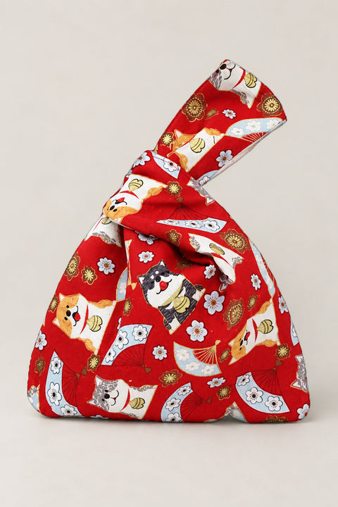 Japanese Knot Bag – red Japanese knot bag with lucky cat and fan print, kimono cloth handbag with unequal handles, studio view