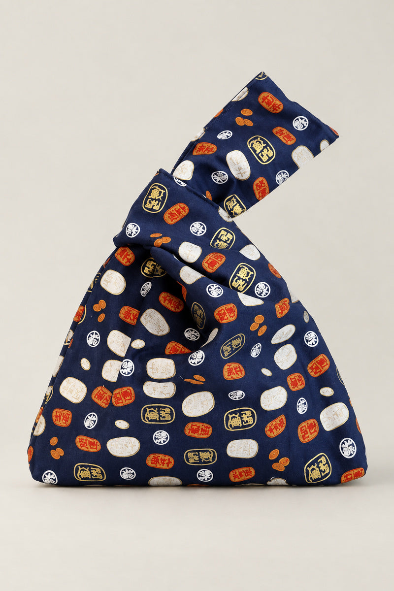 Japanese Knot Bag – navy Japanese knot bag with daruma and coin print, kimono cloth handbag, studio view