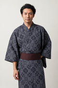 Japanese Pattern Kimono 'Kobana' – charcoal men's kimono with small traditional Japanese pattern print and dark red obi belt, yukata robe, front view on model