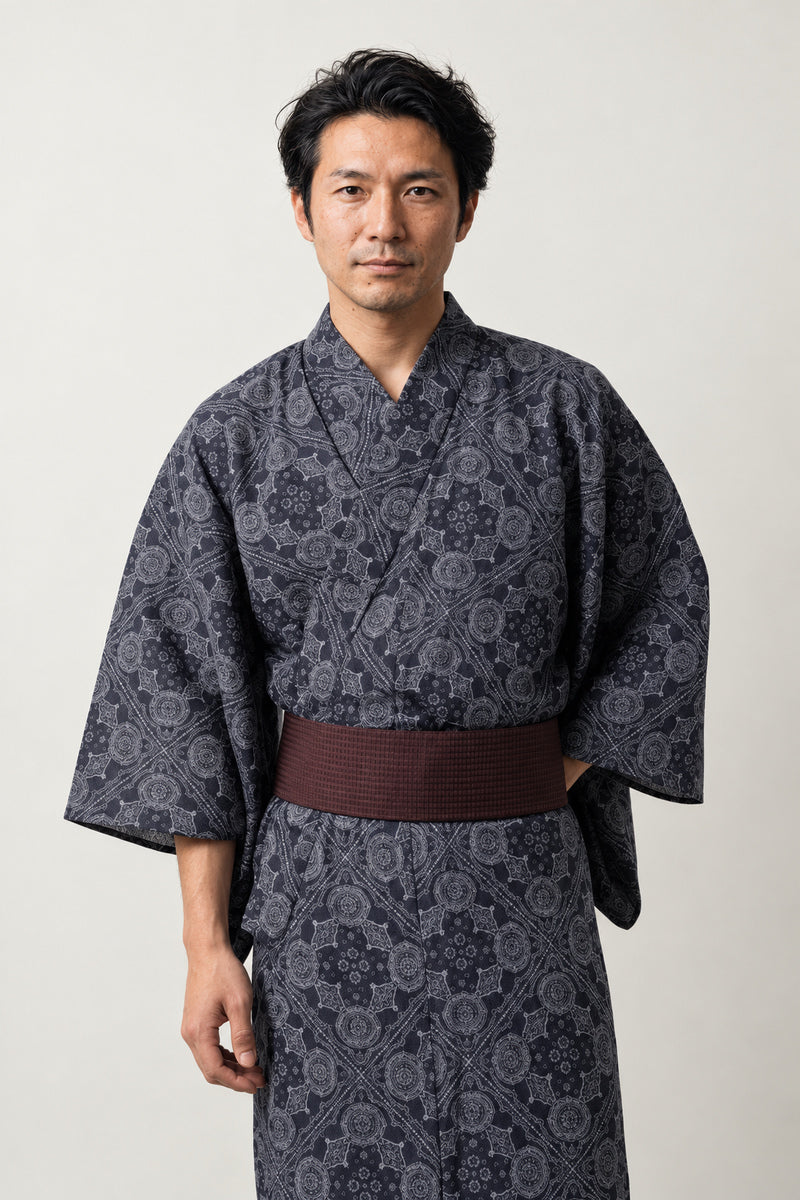 Japanese Pattern Kimono 'Kobana' – charcoal men's kimono with small traditional Japanese pattern print and dark red obi belt, yukata robe, front view on model