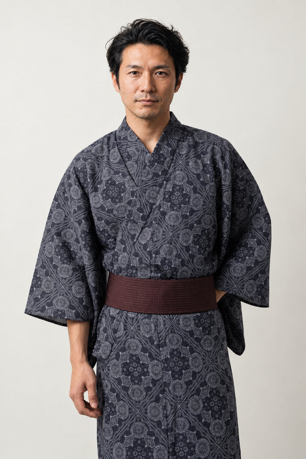 Japanese Pattern Kimono 'Kobana' – charcoal men's kimono with small traditional Japanese pattern print and dark red obi belt, yukata robe, front view on model