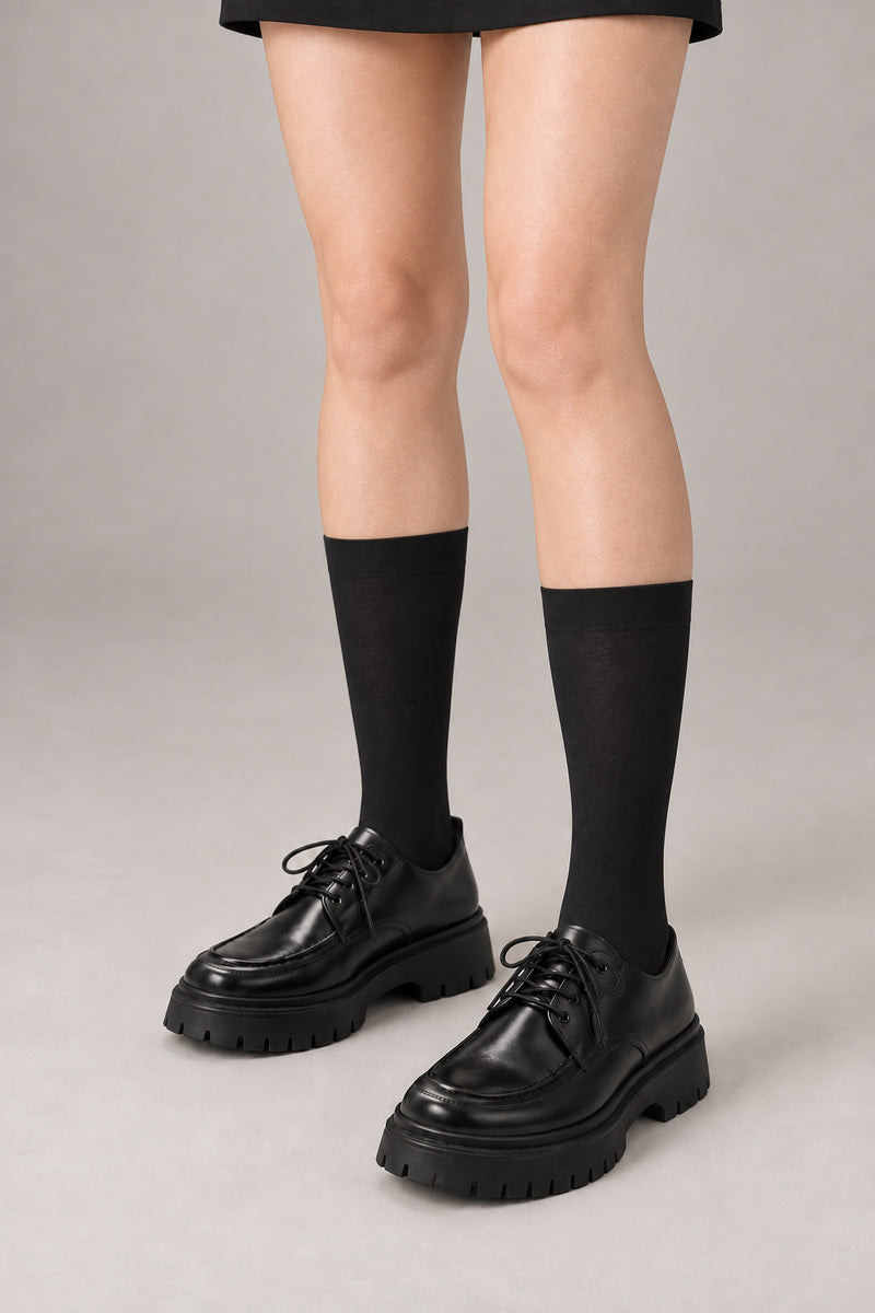 Japanese School High Socks 'Ashimoto' – black knee-high Japanese school socks worn with loafers, front view on model