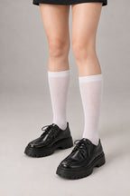 Japanese School High Socks 'Ashimoto' – white knee-high Japanese school socks worn with loafers, front view on model