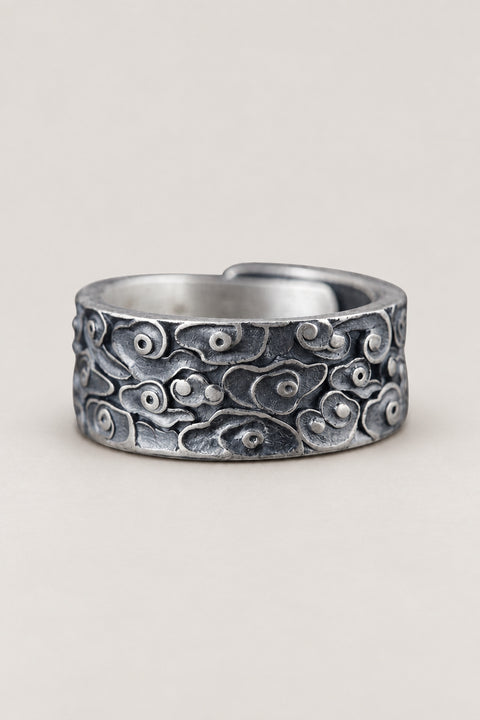 Japanese Silver Ring 'Kumogata' – open sterling silver band ring carved with curling auspicious clouds in dark relief, adjustable Japanese cloud ring, studio view