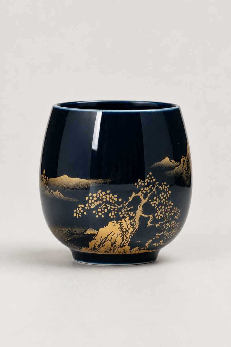 Japanese Tea Cup 'Yunomi' – deep blue glazed yunomi tea cup with gold landscape of pines, hills and a boat, Japanese handleless tea cup, studio view