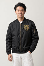 Japanese Tiger Bomber Jacket 'Kinko' – black MA-1 style bomber jacket with small embroidered gold tiger head, Japanese streetwear, front view on model