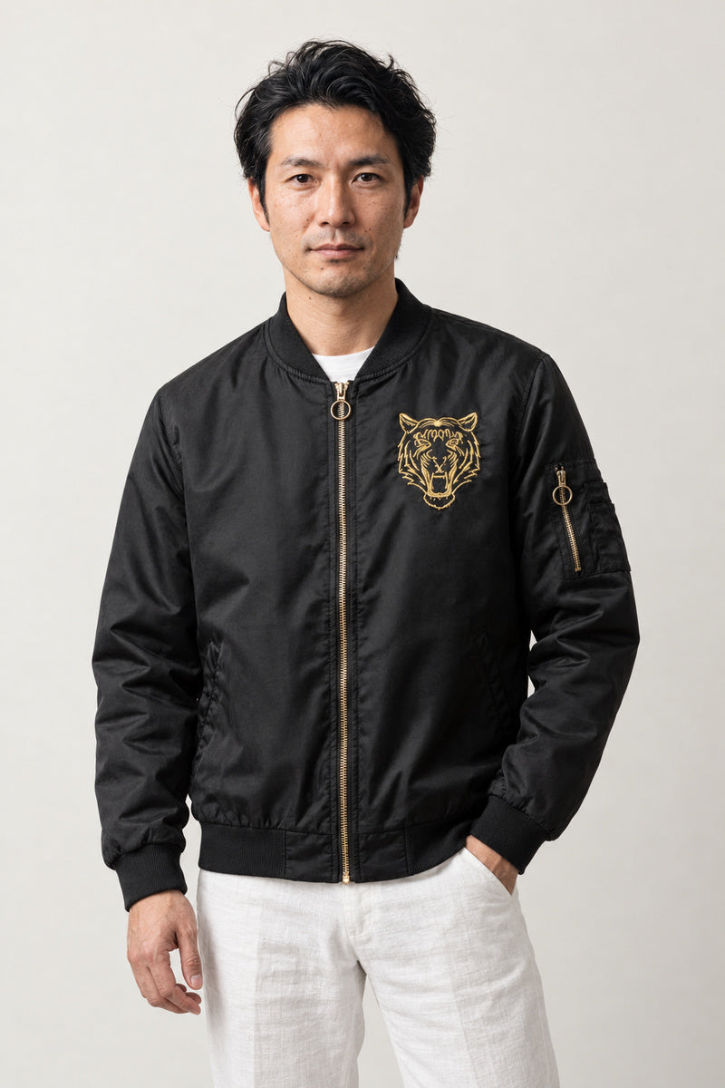 Japanese Tiger Bomber Jacket 'Kinko' – black MA-1 style bomber jacket with small embroidered gold tiger head, Japanese streetwear, front view on model