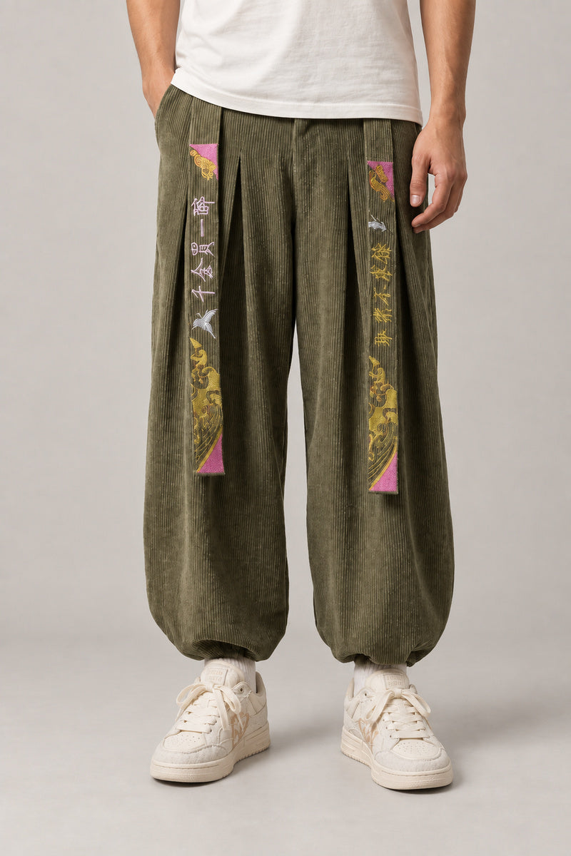 Kanji Band Wide Workwear Pants 'Daiku' – olive green wide workwear pants with kanji print band and pleats, Japanese tobi style trousers, front view on model