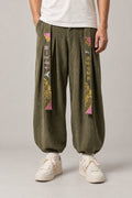 Kanji Band Wide Workwear Pants 'Daiku' – olive green wide workwear pants with kanji print band and pleats, Japanese tobi style trousers, front view on model