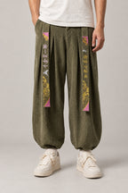 Kanji Band Wide Workwear Pants 'Daiku' – olive green wide workwear pants with kanji print band and pleats, Japanese tobi style trousers, front view on model