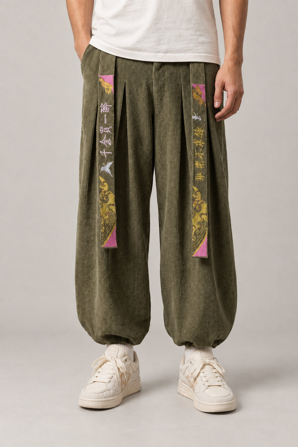 Kanji Band Wide Workwear Pants 'Daiku' – olive green wide workwear pants with kanji print band and pleats, Japanese tobi style trousers, front view on model