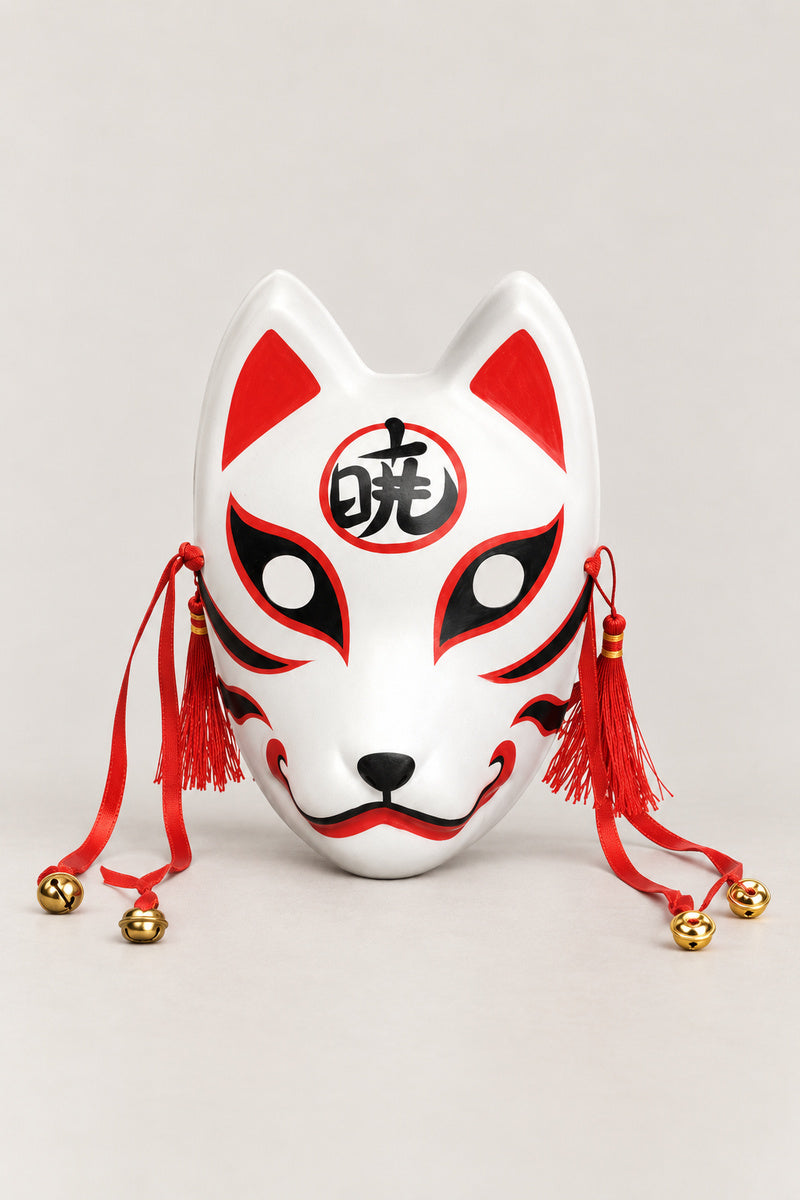 Kanji Kitsune Mask 'Akatsuki' – white kitsune fox mask with a kanji character in a red circle on the brow, red tassels and bells, Japanese kitsune festival mask, studio view