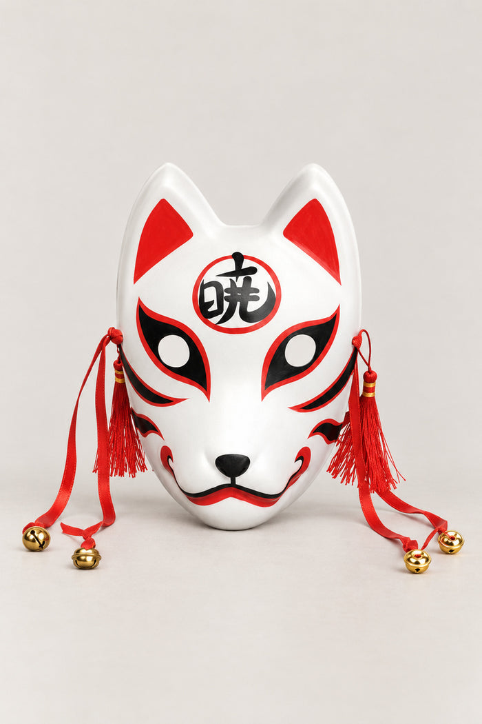 Kanji Kitsune Mask 'Akatsuki' – white kitsune fox mask with a kanji character in a red circle on the brow, red tassels and bells, Japanese kitsune festival mask, studio view