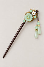 Kanzashi – kanzashi hair stick with jade green disc, gold leaves and pale green drops, studio view
