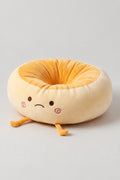 Kawaii Bread Bun Cushion 'Panza' – golden plush ring cushion shaped as a bread bun with a sleepy embroidered face and feet, kawaii Japanese seat cushion, studio view