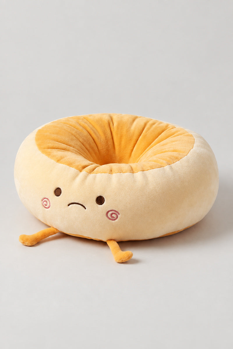 Kawaii Bread Bun Cushion 'Panza' – golden plush ring cushion shaped as a bread bun with a sleepy embroidered face and feet, kawaii Japanese seat cushion, studio view