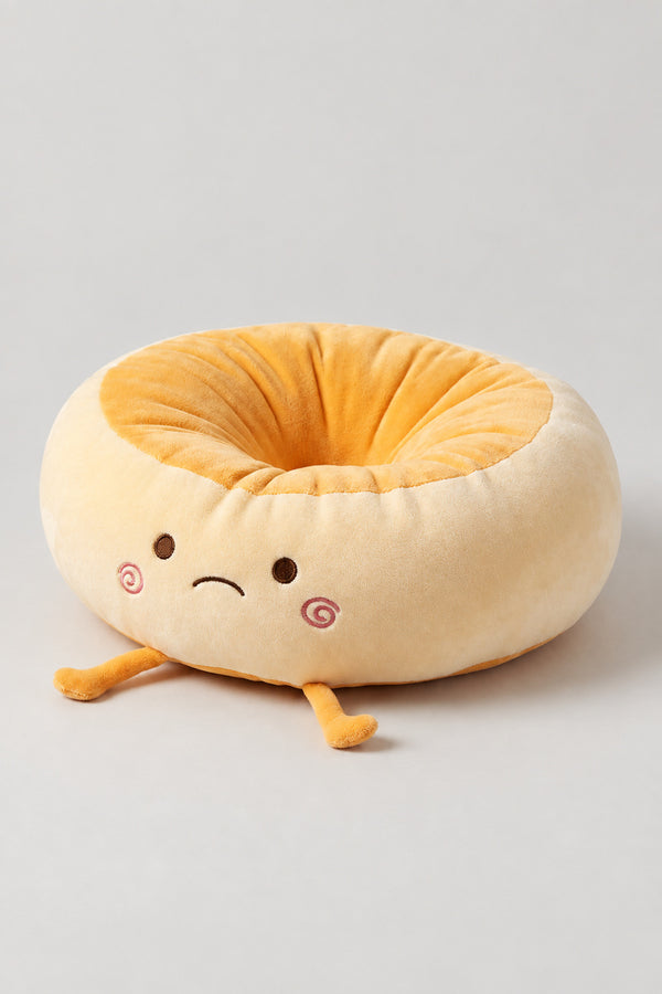 Kawaii Bread Bun Cushion 'Panza' – golden plush ring cushion shaped as a bread bun with a sleepy embroidered face and feet, kawaii Japanese seat cushion, studio view