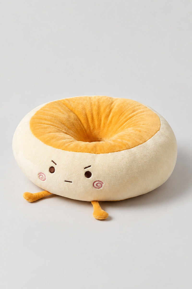 Kawaii Bread Bun Cushion 'Panza' – golden plush bread bun ring cushion with a cheerful embroidered face, kawaii Japanese seat cushion, studio view
