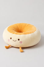 Kawaii Bread Bun Cushion 'Panza' – golden plush bread bun ring cushion with a surprised embroidered face, kawaii Japanese seat cushion, studio view