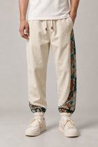 Kimono Panel Floral Joggers 'Hanaobi' – cream joggers with kimono floral print side panel, Japanese streetwear pants, front view on model