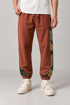 Kimono Panel Floral Joggers 'Hanaobi' – rust version of the kimono panel floral joggers, front view on model