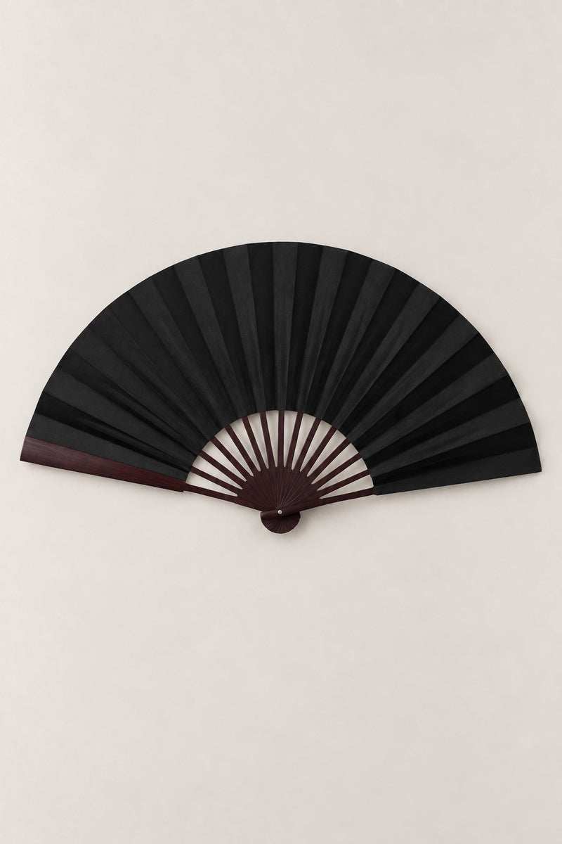 Large Japanese Fan 'Ogi' – black version of the large plain folding dance fan on dark ribs, open, studio view