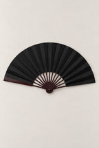 Large Japanese Fan 'Ogi' – black version of the large plain folding dance fan on dark ribs, open, studio view