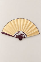 Large Japanese Fan 'Ogi' – gold version of the large plain folding dance fan on dark ribs, open, studio view