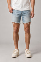 Light Wash Cut Off Denim Shorts 'Kirippa' – light wash cut off denim shorts with frayed raw hem, Japanese streetwear shorts, front view on model