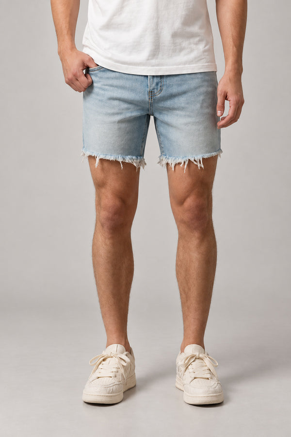 Light Wash Cut Off Denim Shorts 'Kirippa' – light wash cut off denim shorts with frayed raw hem, Japanese streetwear shorts, front view on model