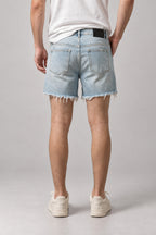 Light Wash Cut Off Denim Shorts 'Kirippa' – back view of the light wash cut off denim shorts, on model