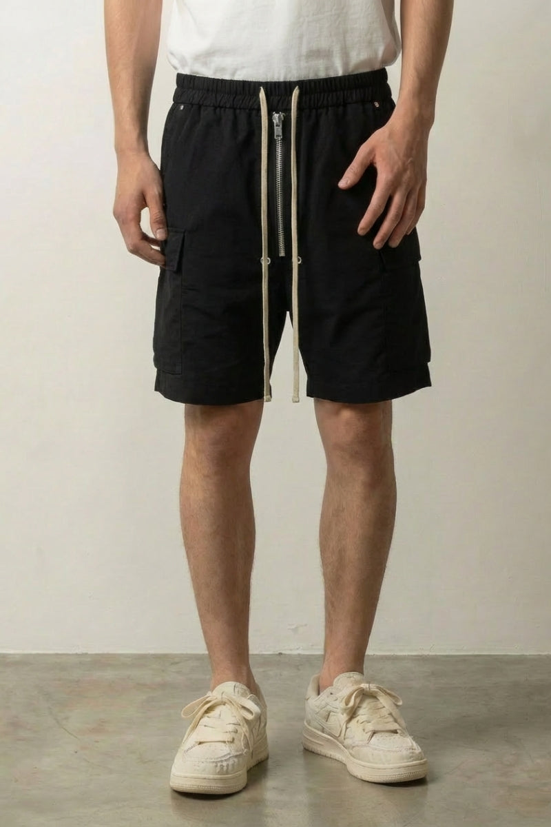 Long Black Cargo Shorts 'Kurokage' – long black cargo shorts with drawstring waist and side pockets, front view on model, studio