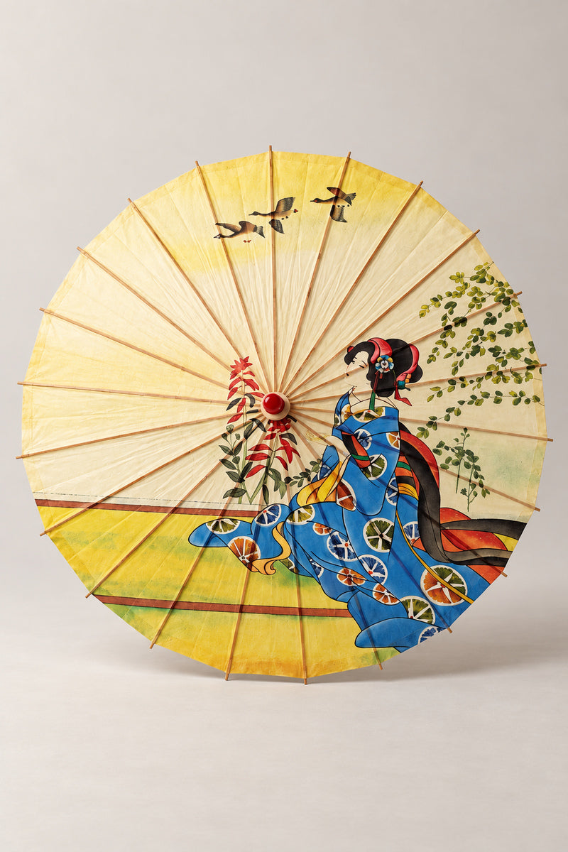 Maiko Wild Geese Umbrella 'Karigane' – yellow parasol printed with a seated maiko in blue kimono, wild geese and a willow, Japanese wagasa parasol with wooden frame and paper-effect canopy, open, studio view