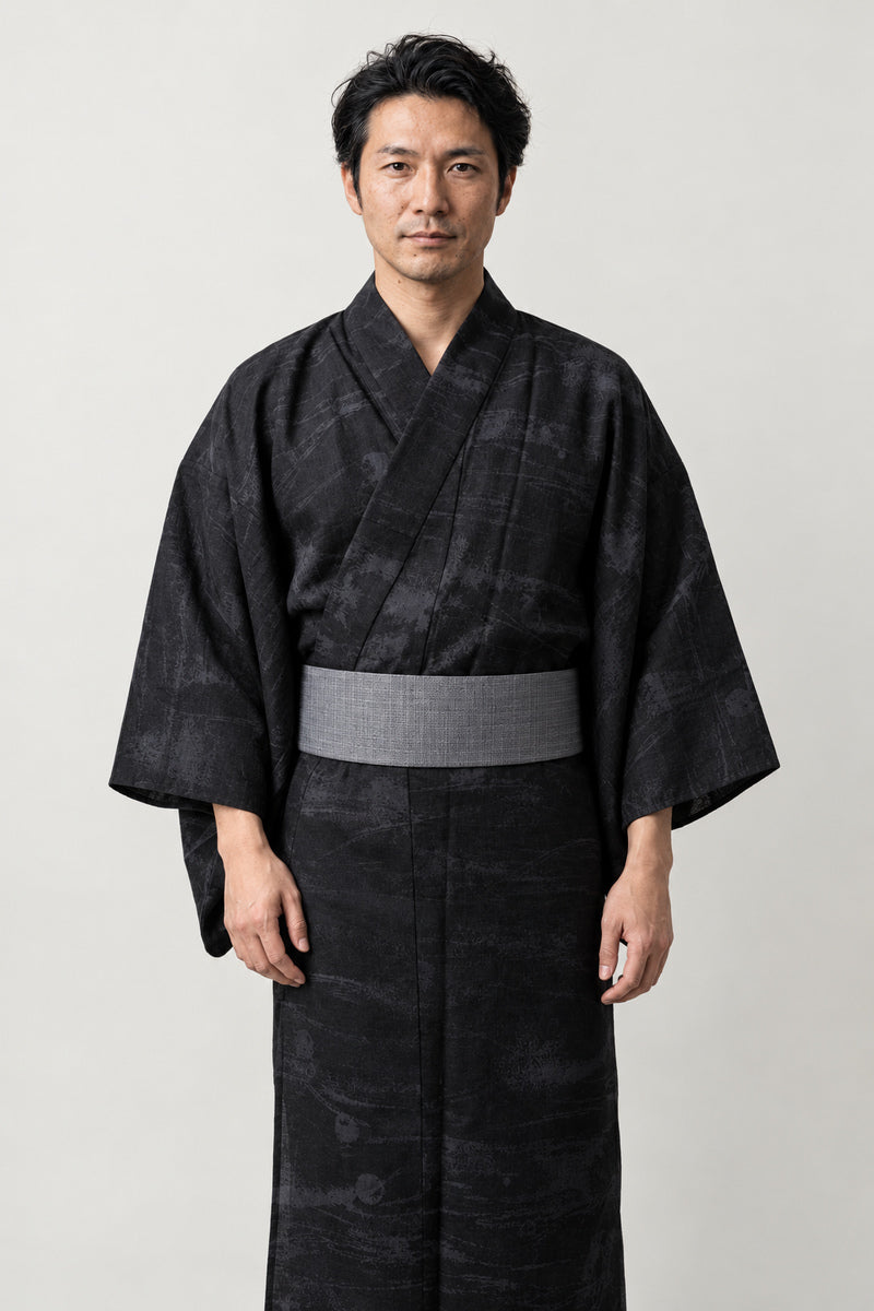 Men's All Black Kimono 'Kurokumo' – all black men's kimono with tonal cloud print and grey obi belt, plain Japanese yukata robe, front view on model